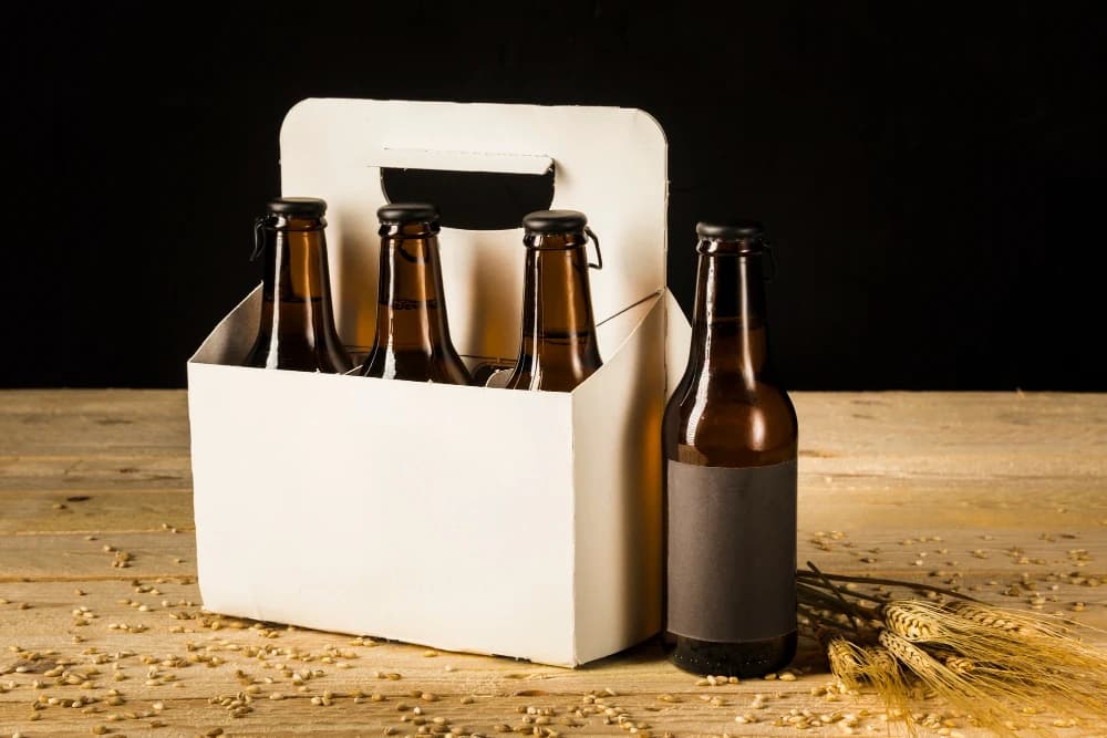 /beer-packaging/beer-bottle-carton-box-ears-wheat-wooden-surface.webp