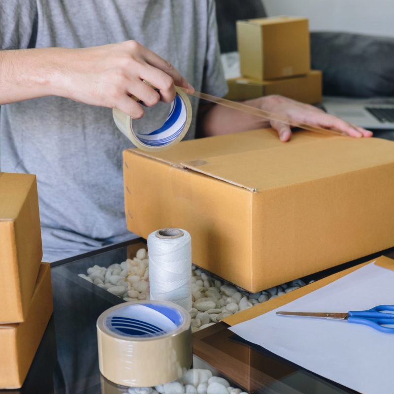 Small business parcel for shipment to client, Young entrepreneur SME freelance man working with packaging their packages box delivery online market on purchase order and preparing package product.