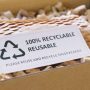 Net zero waste go green SME use eco friendly care sign plastic free symbol packaging carton box wrap paper in small shop retail store. Chva dried water hyacinth on desk reuse packing parcel supplies.